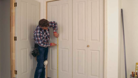carpenter fitting a bifold door