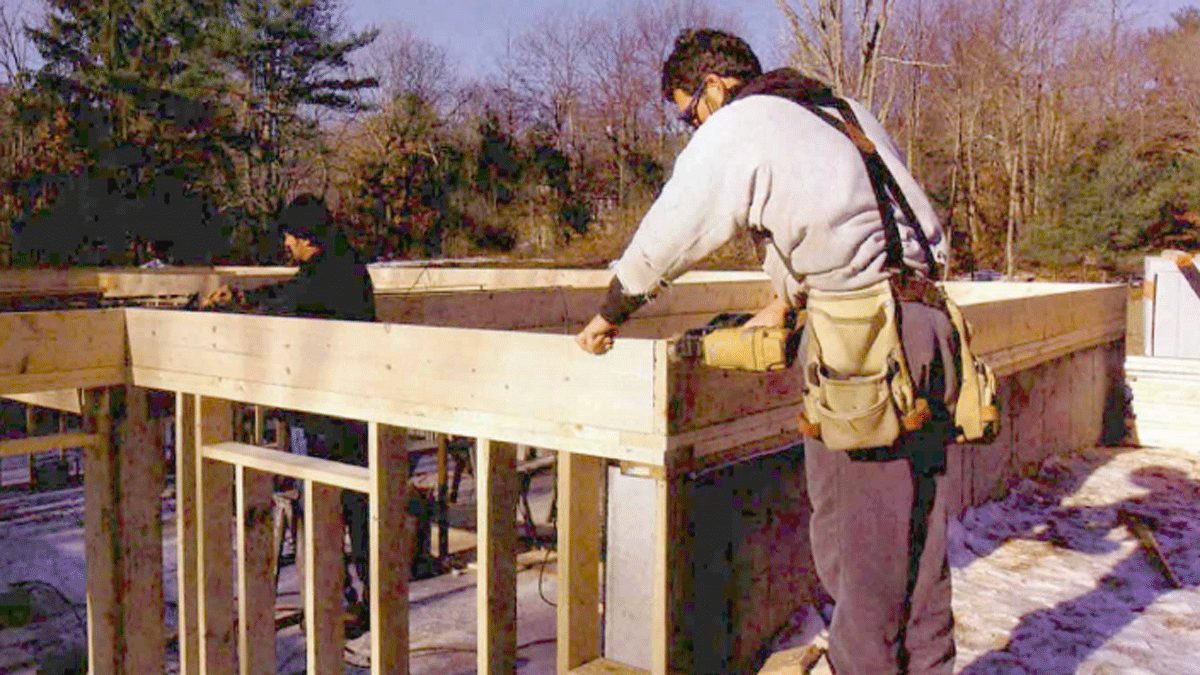 Builder framing a house