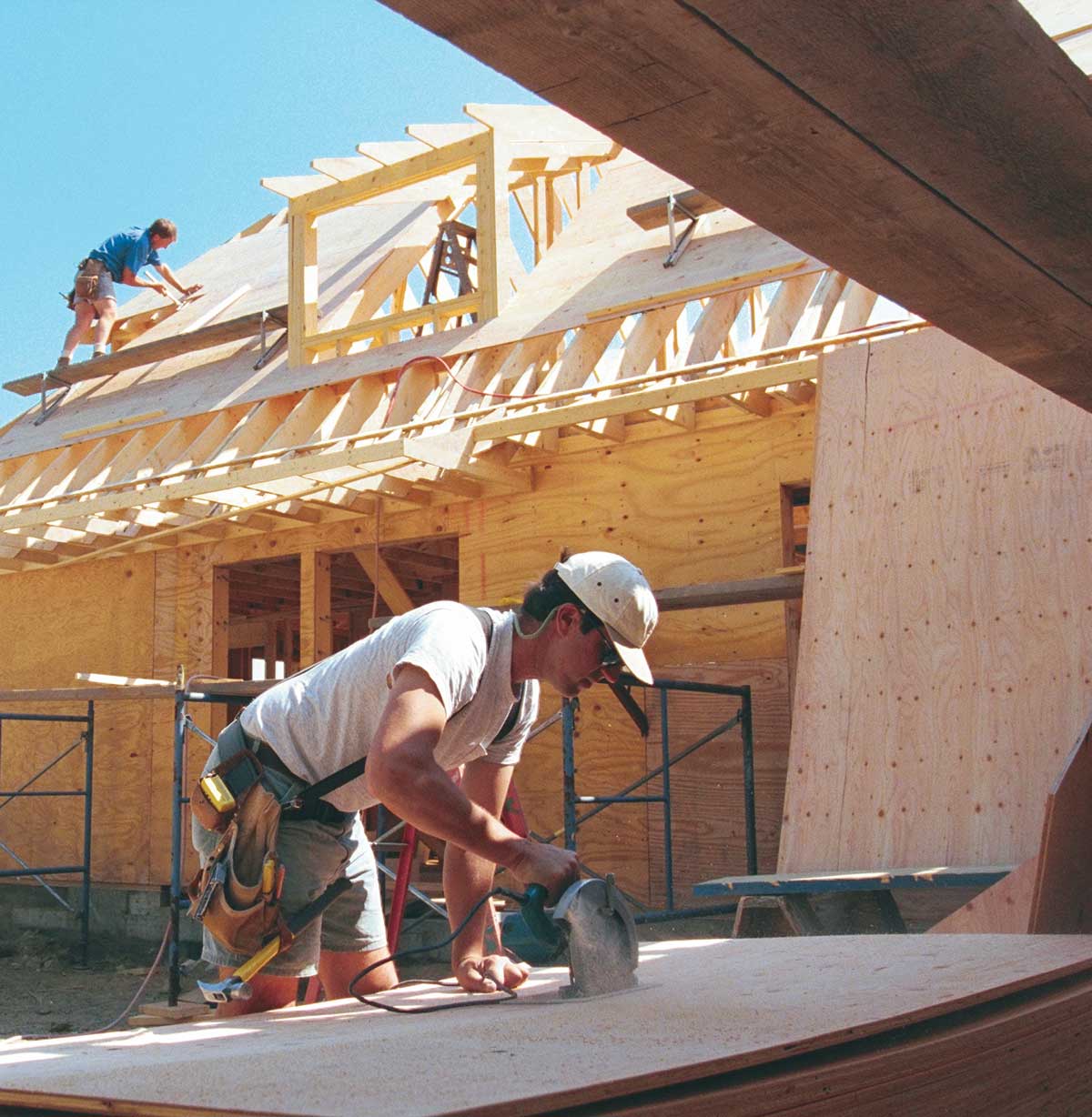 Cutting on the ground is safer and quicker. Crew members on the roof do the nailing while a designated cutter prepares the sheathing on the ground. The cutter can also keep track of templates and scrap pieces to use the sheets more efficiently.