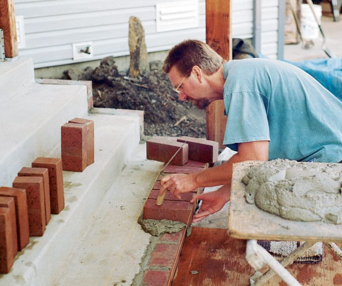Strings in front and back of the bricks keep them in line and at the right slope during installation