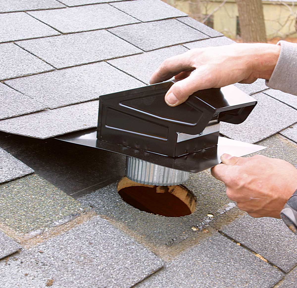 The vent faces down the roof. Slip the vent into the hole with the opening facing down, and secure it at each corner with galvanized roofing nails.