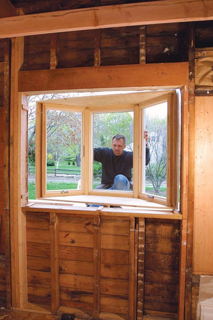 Lift the window onto the support. There is no need to muscle the window into the opening in one shot.