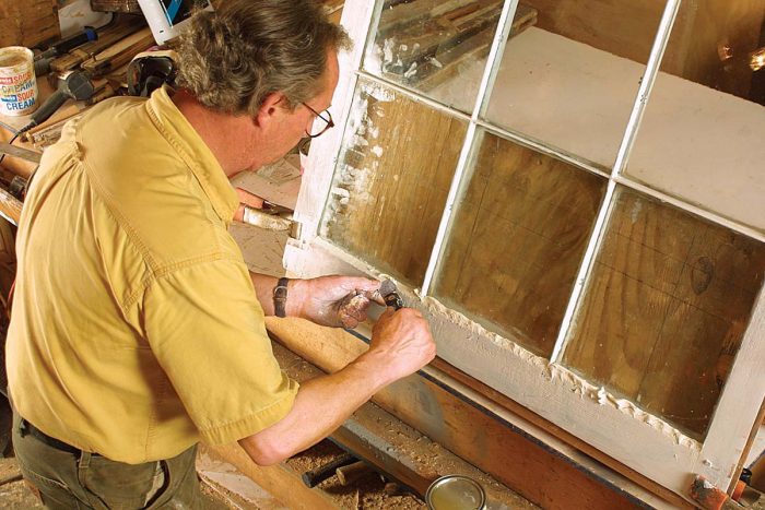 After lubricating a putty knife with boiled linseed oil, he tools the glazing compound using an index finger as a guide. Finally, he eliminates minor imperfections in the glazing by wiping downward with a taping knife.