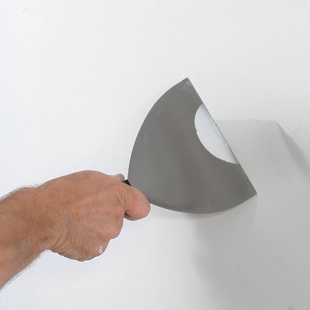 Essential patching tools. Use a 6-in. taping knife and a 5-in-1 tool for wall prep