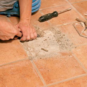 After the tile is removed, all old thinset and grout are scraped from the substrate, which then is vacuumed clean.