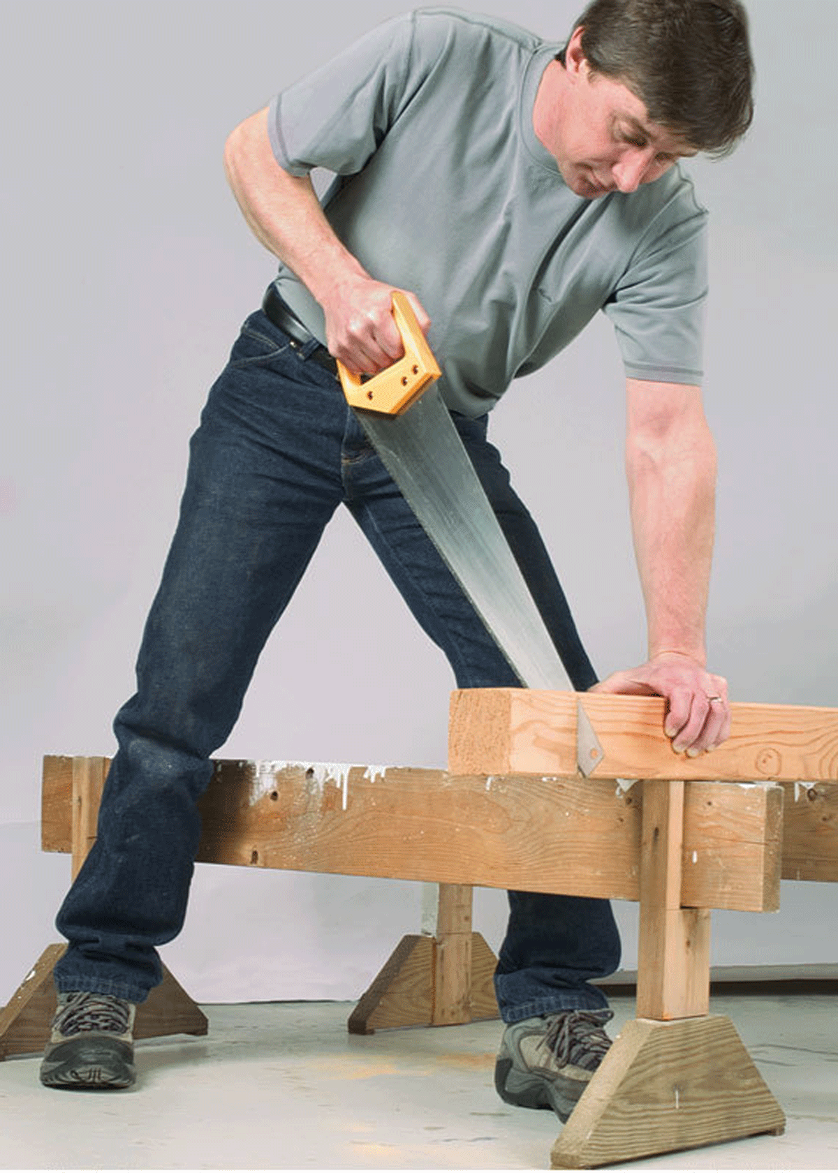 Step 3: Put your weight behind the blade. A good stance is important when you’re using a handsaw to cut thick material like this 4×4. Low sawhorses or other supports will enable you to get your hand, elbow, and shoulder in line with the blade.