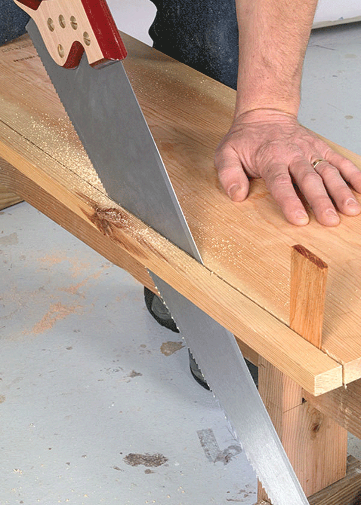 Rip with the right saw. Ripping a board (cutting with the grain) is usually more difficult than crosscutting. Use the right saw: a traditional Western-style ripsaw (shown in the photo), a Japanese ripsaw, or a modern hybrid saw. Cutting action is best with the blade at a 60° angle. If the kerf starts to close and pinch the blade, use a wedge to keep it open.