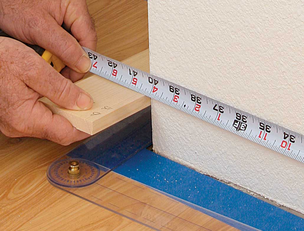 The rounded edge of drywall corner bead can make measuring an outside corner difficult, so a block works well.
