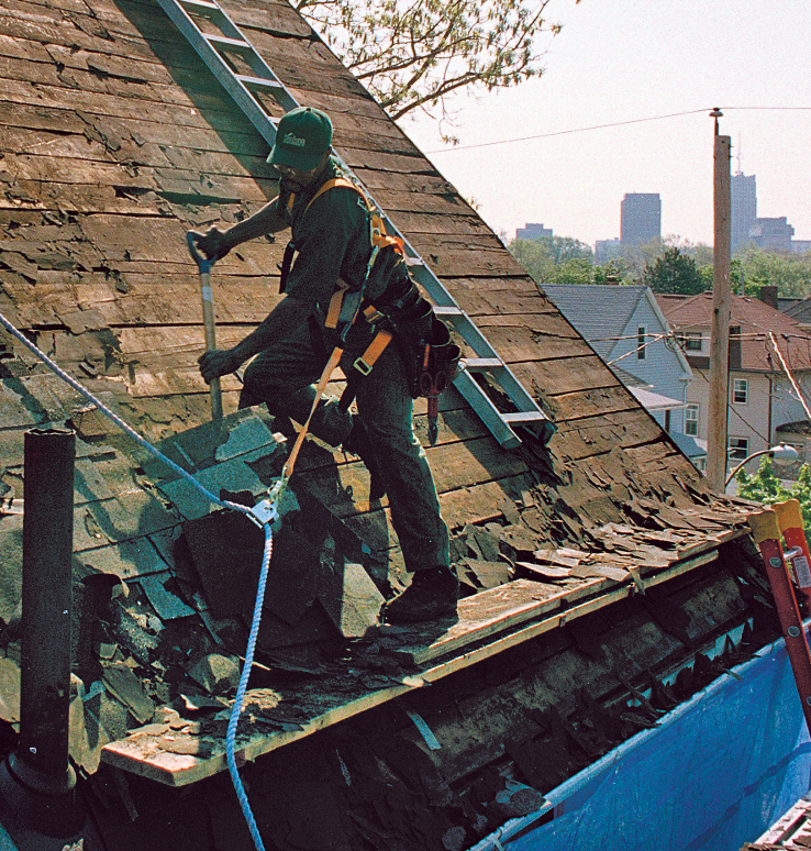 A safe setup makes the job go more quickly. Tied off to the ridge, this roofer has the extra peace of mind that a misstep won’t be fatal. The roof ladder provides safe footing while tearing off from top to bottom. 