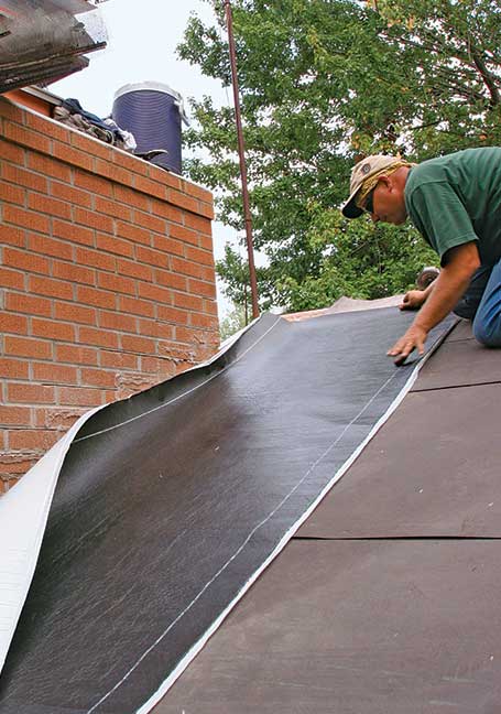 2. Extra protection. Use roofing membrane along the side, top, and bottom of the chimney. I fold it up the chimney wall as a final line of defense against windblown rain. Cut back the felt about 18 in. so that the membrane can stick to the roof.