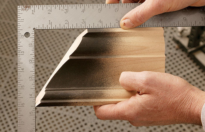 To check the cut, measure the length of the miter