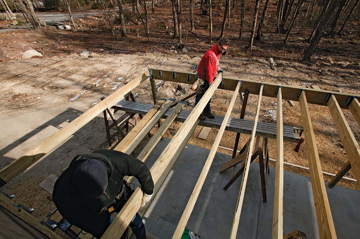 Laying out and dropping joists into hangers.
