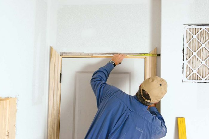 Tip the door in place; then center it by measuring the space between the drywall and the casing.