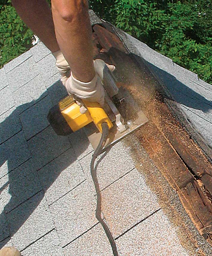 Remove a strip of sheathing. Cut the sheathing back 2 in. on conventionally framed roofs and on truss roofs with ridge blocking. On truss roofs without ridge blocking, cut a 1-in. strip. Nail or screw down the top edge of the remaining sheathing.