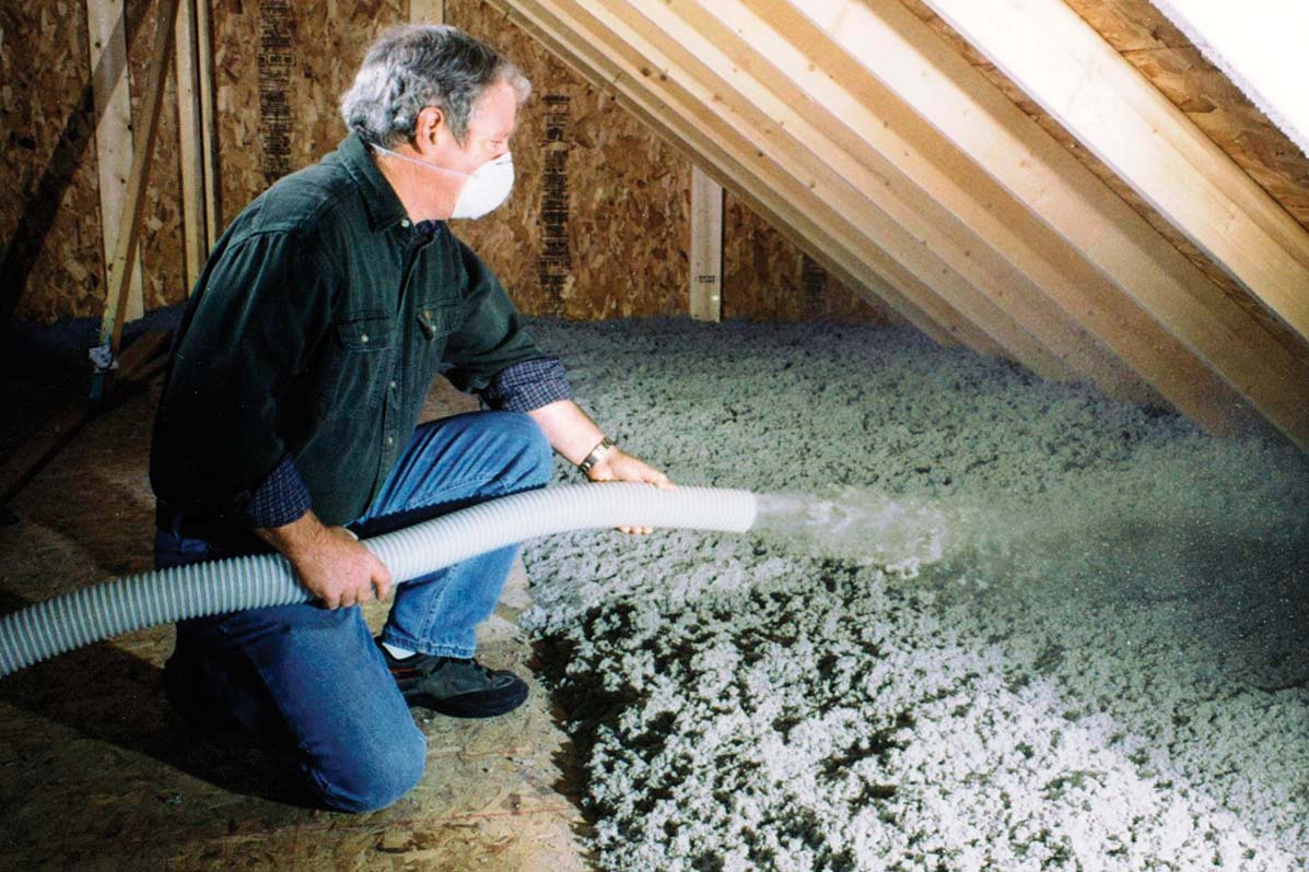 Cellulose insulation being applied.