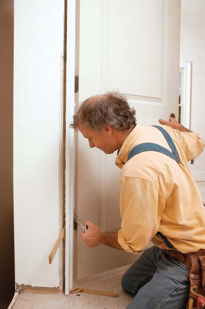 insert an adjustable wrench or something of a similar size between the hinge leaves, then slowly close the door.