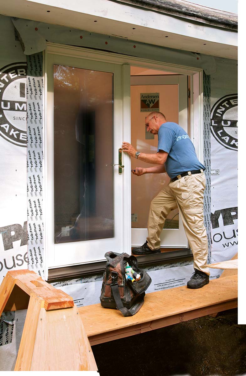 Once the door operates easily and is fully fastened, tape over the door’s installation flange with flexible flashing, and install the hardware.