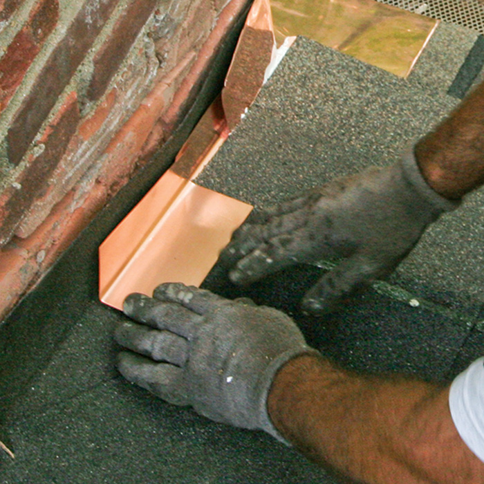 Install step flashing between the chimney and every course of shingles