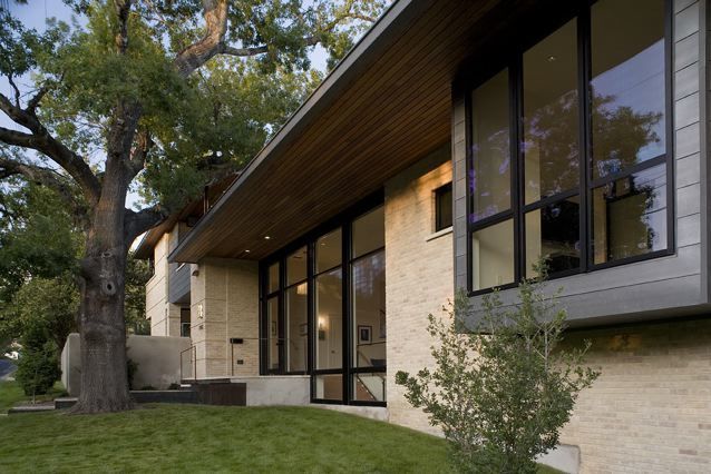 modern tan brick house with large glass windows
