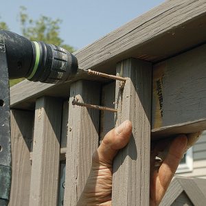 Secure the railing. Remove the balusters from each rail section, and replace the bad ones. For a better connection, drill pilot holes into each end of the balusters, and fasten them to the 2x4 rails with four screws, two at each end.