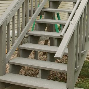 According to code, stairs need at least one handrail continuous from top to bottom and whose ends either terminate onto newels or return safely. Here, the handrail ends run long and don’t have safety returns onto the guardrail.