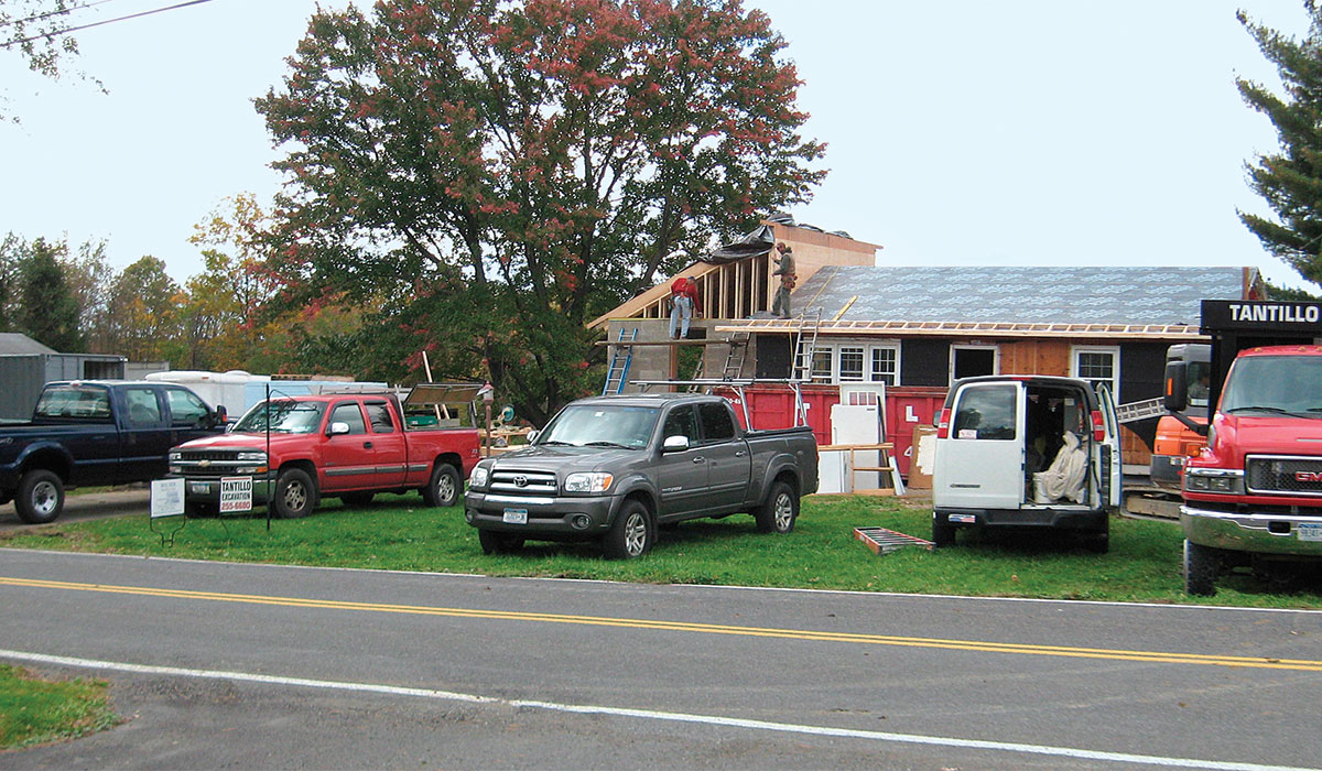 pickup trucks lined up in front of house 