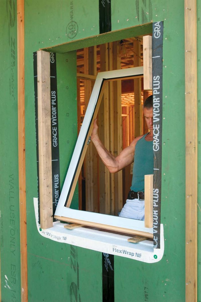 he window frames (free of their heavy sashes) are tipped into place.
