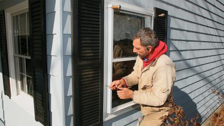 Mike Guertin working on a storm window