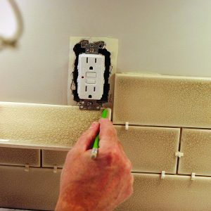 backsplash tile fitting around outlet