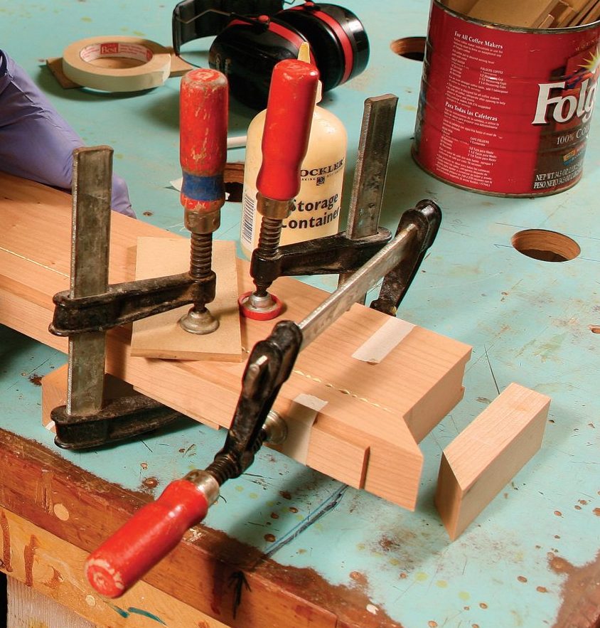 glueing and clamping the front edge of the mantel band to the shelf