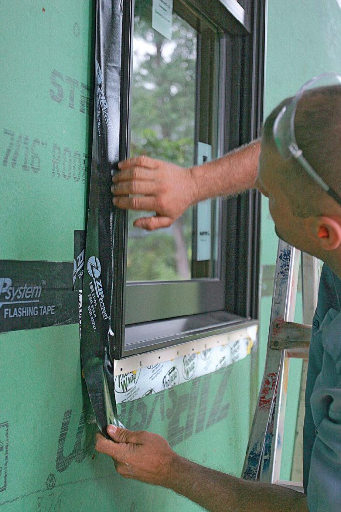 Zip System Tape is 3-3⁄4 in. wide, which is wide enough for it to be adhered to the sheathing, across the nailing fin, and onto the side of the window frame.