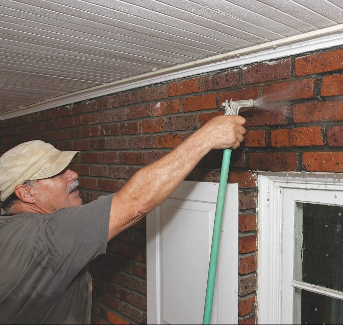 dampening the area of the brick wall that needs to be repaired