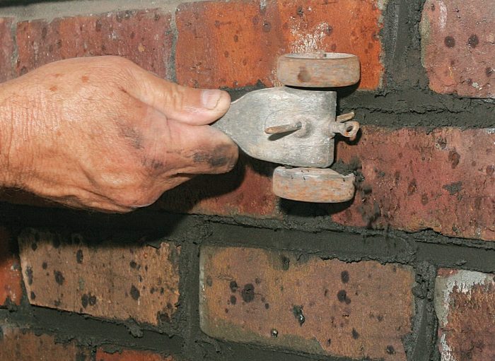 rake out the excess mortar from the brick