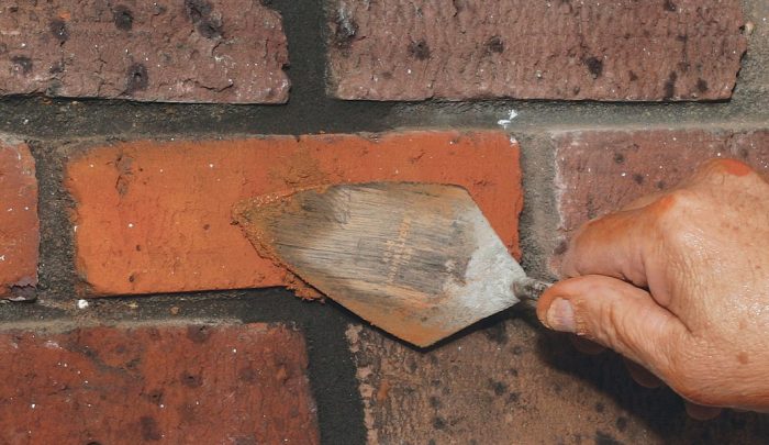 fill the cracked brick and then smear it out with a trowel