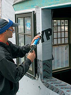 Run a 1⁄2-in.-wide bead of caulk along the sides and top of the window opening