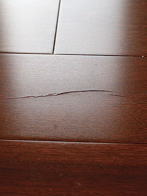 Small cracks can be filled. A board with cracks in its face doesn’t always need to be replaced. The board shown here may be repaired with a touch-up kit.