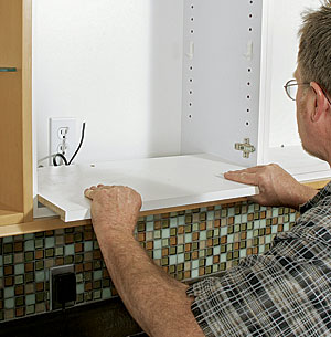 person placing cabinet 