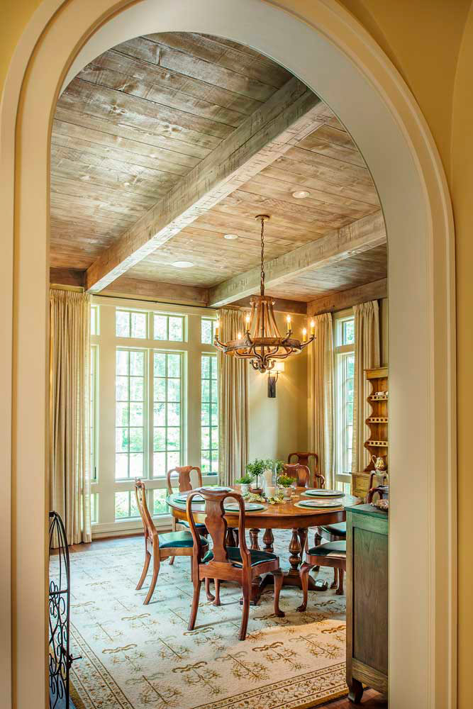 Here an elegant dining room boasts views of the picturesque grounds through divided lite casement and awning windows.