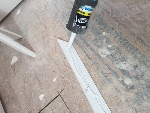 Apply a bead of paintable adhesive caulk to the back side of the molding pieces.