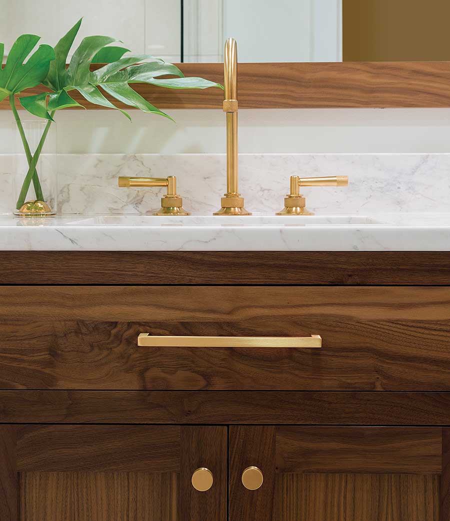 brown vanity with marble and golden faucet like counter top and golden 