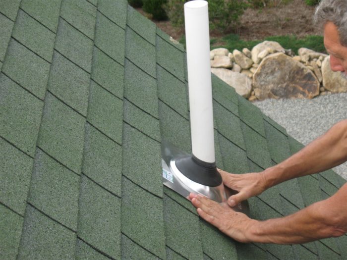 A couple of roofing nails can be driven at the bottom corners of the flashing pan to ensure it stays put in high wind.