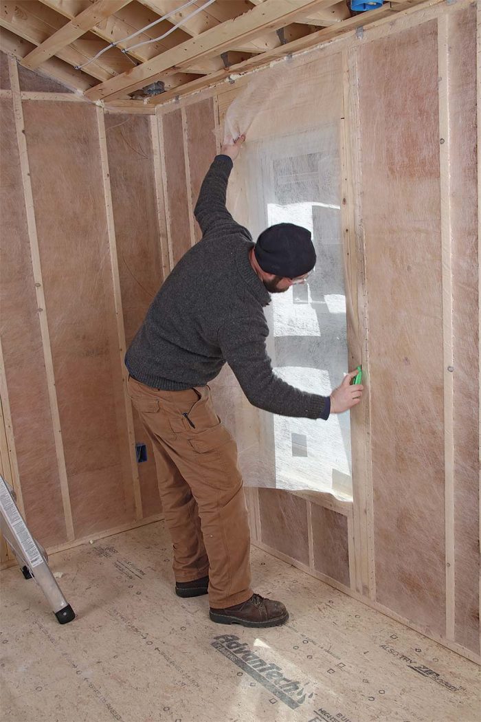 Trim around doors and windows to install netting for dense-pack cellulose insulation