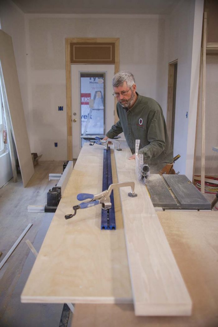 To put a straight edge on a board on the job site, make a long plywood sled, clamp the board on it, and run the sled against the tablesaw fence, making sure the blade is set accurately to 90°.
