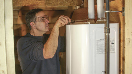 This tankless water heater has hose clamps for connecting the combustion-air and flue-gas piping to the top of the water heater.
