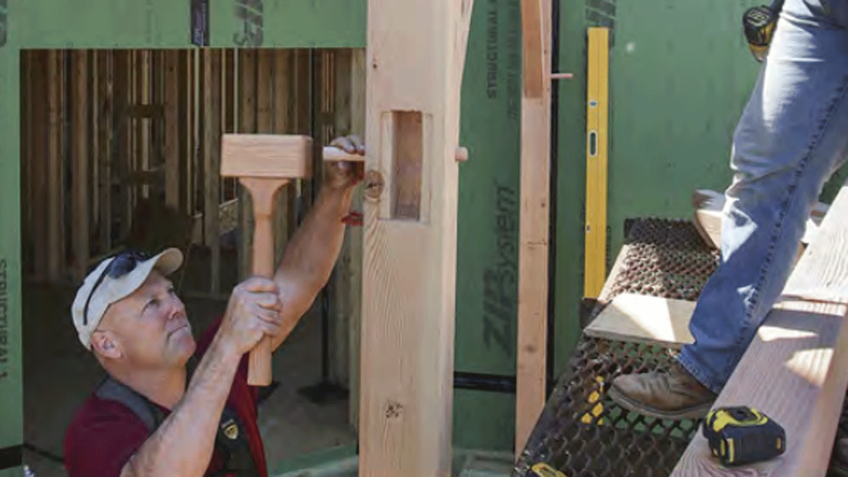 builder working on a timber frame