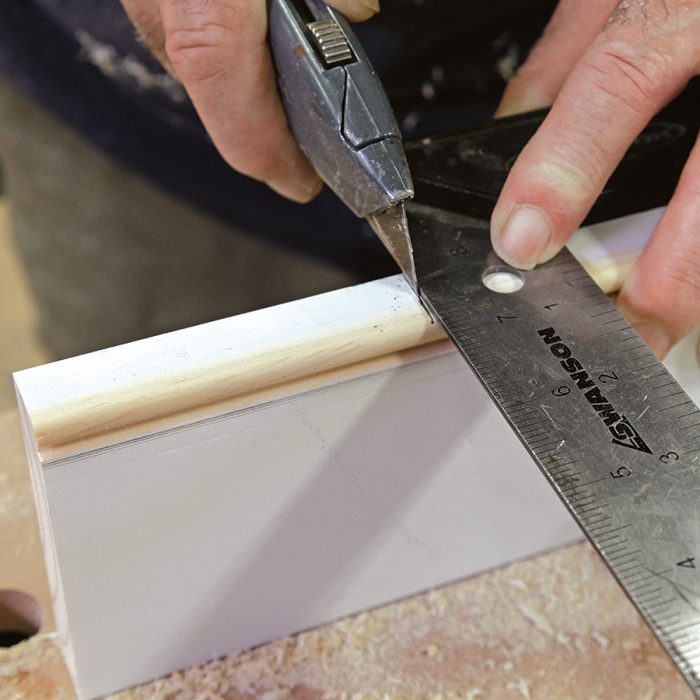 Use a square and a utility knife to score the cutline