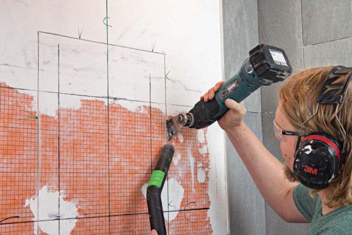 An oscillating multitool makes short work of wallboard cuts, and a vac hose tames the dust.