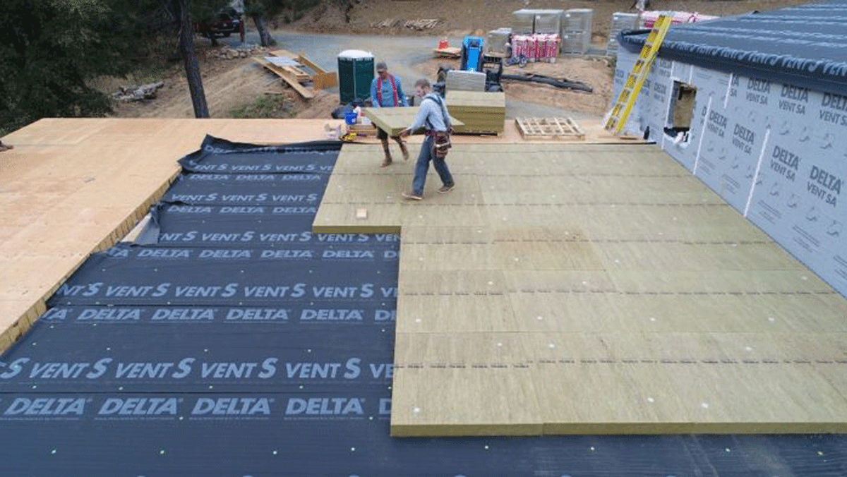 TopRock DD is a dense, rigid Rockwool panel that doesn't compress underfoot. It's intended for low slope roofs like this.