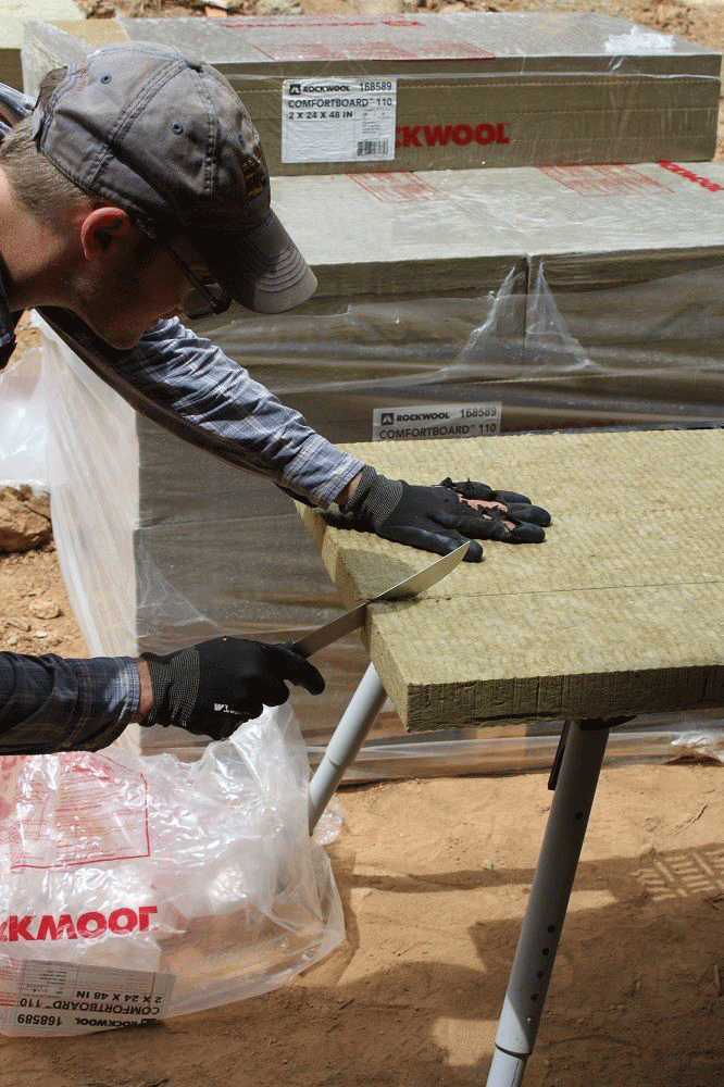 The Rockwool was cut with bread knifes and handsaws depending on the carpenter's preference.