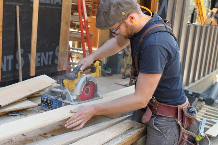 cutting the wood board to match the roof slope